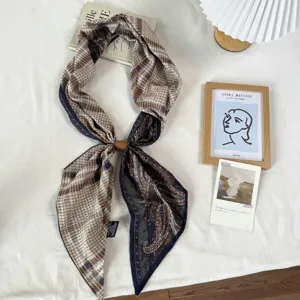 Close up detail view of the Maillard style patterned long silk scarf with magnetic buckle.