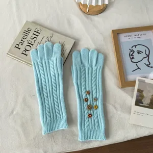 Long blue knit gloves with vintage button details, warm winter touchscreen gloves for women.