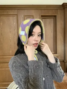 Cozy winter warm knit plush earflap hat for women, cute purple yellow polka dot design.