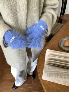 Detail shot of cozy blue fluffy fuzzy touch screen gloves for women winter daily wear.