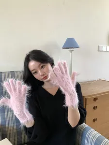 Pink fluffy touchscreen gloves detail shot, soft plush split-finger winter warm gloves.