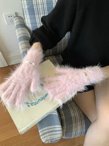 Pink fuzzy touch screen gloves detail view, soft plush winter knit gloves with cute label.