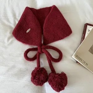Detailed close-up of the knitted pom-pom earmuffs, featuring soft texture and lovely bow ties.