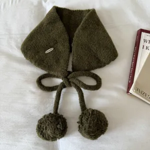 Detailed view of the cute olive green knitted earmuff with pompom and tie decoration.