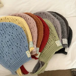 Colorful knitted balaclava hat with hollow-out design, cute ear flaps and braided ties.