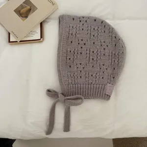 Knitted balaclava hood detail showing hollow out weave and cute side tie design.