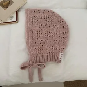 Pink knitted balaclava bonnet with cute ties, hollow out design, cozy winter warm hat style.