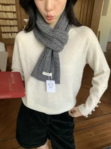 Cozy grey cable-knit wool scarf for women, warm thick winter neck warmer fashion accessory.