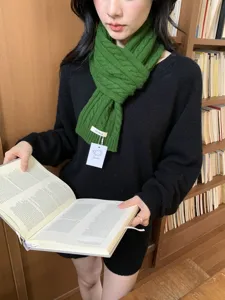 Classic green cable knit wool scarf for women, cozy winter thermal neck warmer accessory.