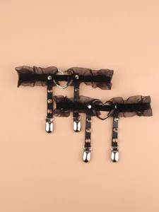 Black lace garter belt with metal heart ring and punk rivets for women fashion outfit.