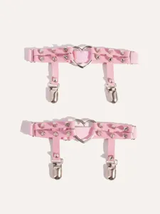 Close-up detail of pink faux leather and elastic leg garter with heart ring and metal clips.