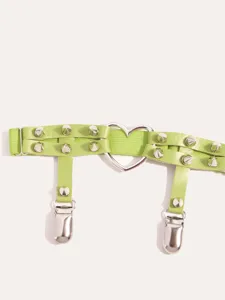 Detailed view of green leather garter belt featuring metal cone studs and heart ring.