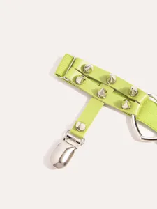 Close-up detail view of neon green punk style garter featuring metal spikes and clip accessory.