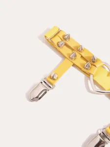 Yellow punk style garter belt with metal spikes and heart ring accessory for women.