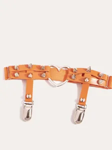 Orange punk thigh garter belt detail, featuring metal heart ring and gothic metal clips.