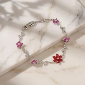 Detail shot of copper zircon floral branch bracelet featuring charming red and pink petal stones.