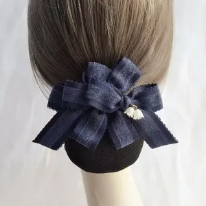 Dark blue ribbon bow hair net bun cover with cute lily of the valley charm for professional use.