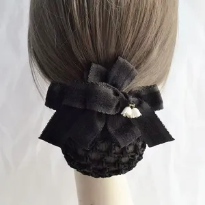 Black velvet hair net detail shot showing bow and lily of the valley pendant, professional bun.