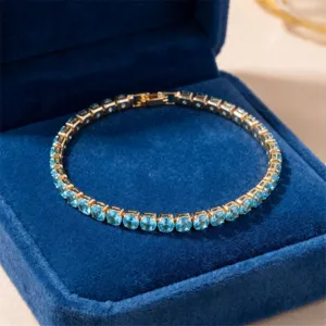 Fashion copper inlaid zirconia tennis bracelet for women, elegant round blue stone jewelry.