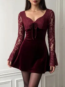 Close-up detail of the burgundy velvet lace long sleeve mini dress featuring a tie-front bodice.