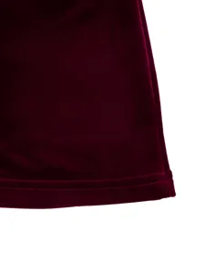 Burgundy velvet dress hem detail, premium soft fabric texture, fine stitching close up