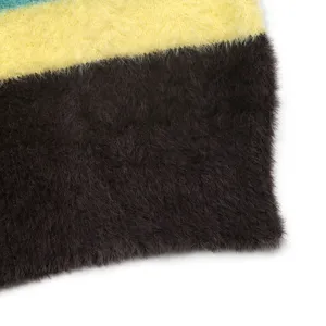 Gros plan détaillé sur le pull douillet à rayures duveteux avec une texture très douce.