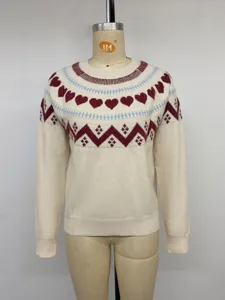 Close-up of women's cozy knit sweater featuring cute maroon heart and blue geometric patterns.