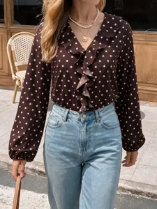 Detailed view of the women long-sleeve polka dot V-neck ruffle bodysuit in outdoor street style.