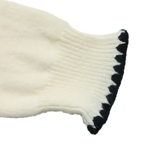 Knitted cardigan cuff detail, stylish white sweater with black wavy pattern trim