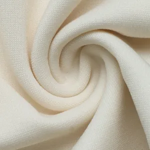 Detailed view of the premium off-white knit fabric texture, soft and delicate material.