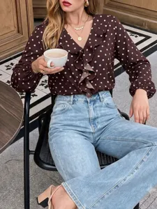 Detail view of women's polka dot V-neck ruffle blouse showing elegant sleeve and collar design.