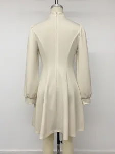 Back view detail of elegant beige long sleeve dress with stand collar and zipper.