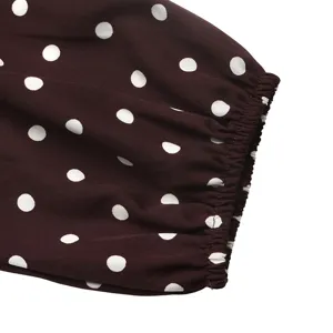 Close-up detail of women's polka dot long sleeve garment cuff, elegant and comfortable.