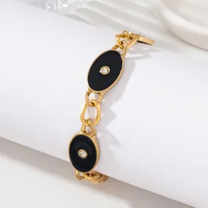 Bracelet en chaîne dorée à charms ovales en émail noir vintage avec cristaux étincelants