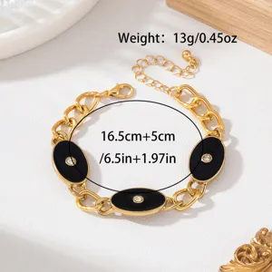 Bracelet chaîne grossier doré rétro avec plaques émaillées ovales noires et strass.