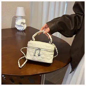 White quilted mini vanity shoulder bag with chain strap, stylish crossbody bag for women.