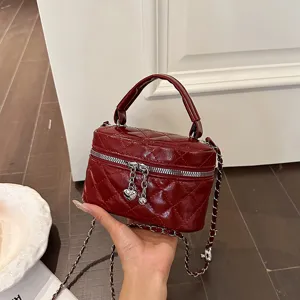 Red quilted mini shoulder bag with chain strap and heart zipper for women winter fashion style.