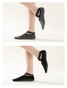 Professional women yoga socks with anti-slip grip dots and shiny gold strap details.