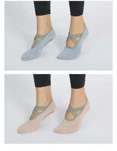 Detailed view of non-slip yoga socks featuring cross straps and dotted grip soles.