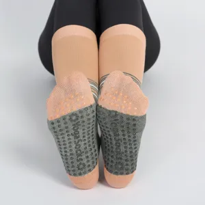 Women non-slip yoga socks with grip dots, comfortable striped athletic socks for fitness.