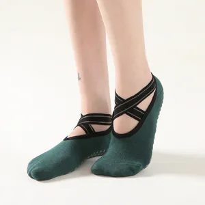 Women's non-slip yoga socks with metallic strap cross design for professional sports dance fitness.