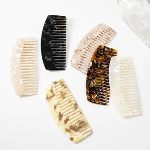 Acetate wide tooth hair comb with elegant marble texture, curved design for daily hair styling.