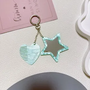 Mint green acrylic heart comb and star mirror keychain detailed view, cute bag pendant accessory.