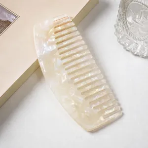 Acetate hair comb with marble texture, curved wide-tooth design for daily hair styling.