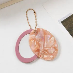 Ovaler Spiegel Schlüsselanhänger Anhänger mit Marmor Glitzer Cover und pinkem Rand Tasche.