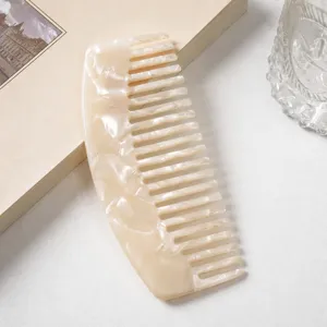 Detailed view of the luxury marble texture curved acetate wide-tooth comb for daily hair styling.