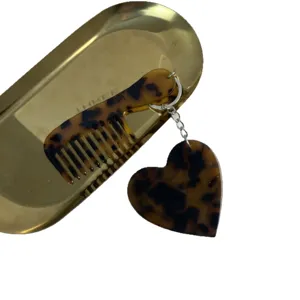 Acetate heart comb keychain portable bag pendant stylish minimalist purse charm accessory.