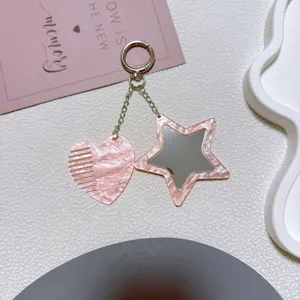 Pink marbled acrylic heart comb and star mirror keychain detail view, cute bag pendant accessory.
