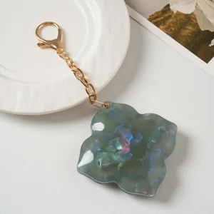 Chic four leaf clover keychain with gold chain and mirror acrylic charm for daily bag decor.