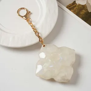 Detailed view of the chic four leaf clover mirror keychain and stylish bag charm accessory.